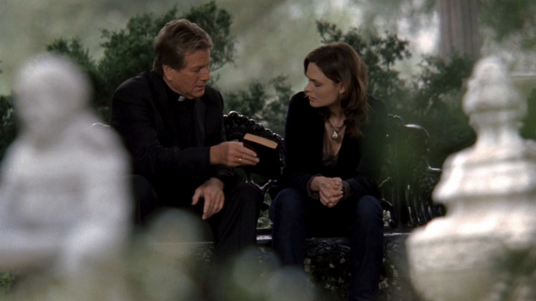 Ryan ONeal's Max Keenan sits alongside Emily Deschanel's Temperance Brennan in a garden in Bones