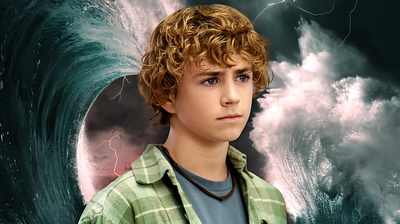 Percy Jackson standing among rolling waves.