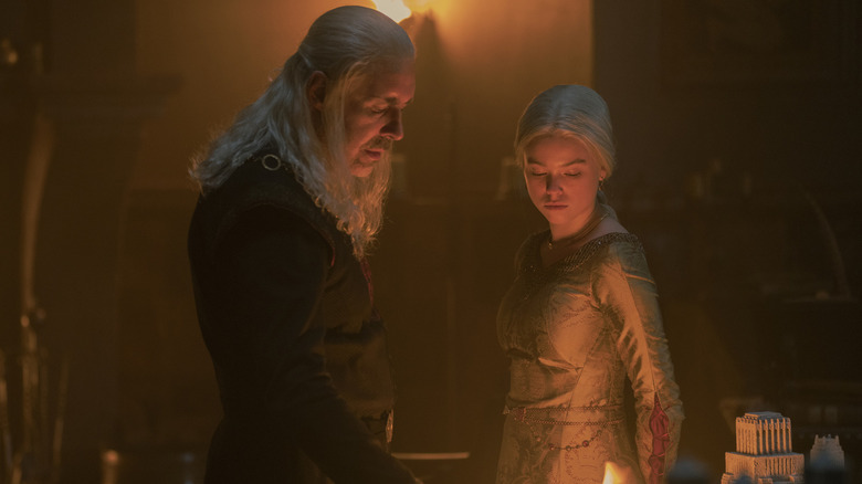 Viserys and young Rhaenyra standing over a fire on House of the Dragon