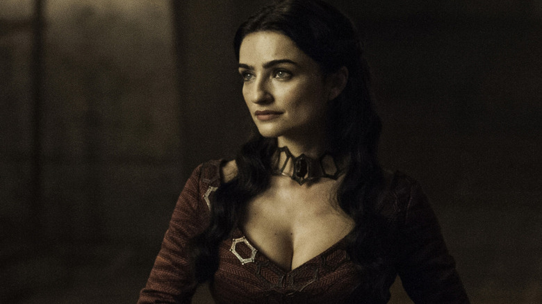 Kinvara the Red Priestess wearing a necklace and red robe on Game of Thrones