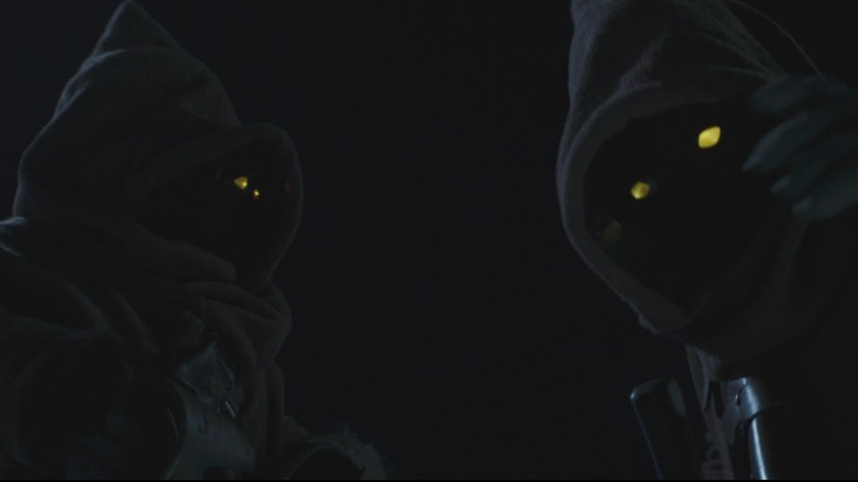 Two dark figures yellow eyes