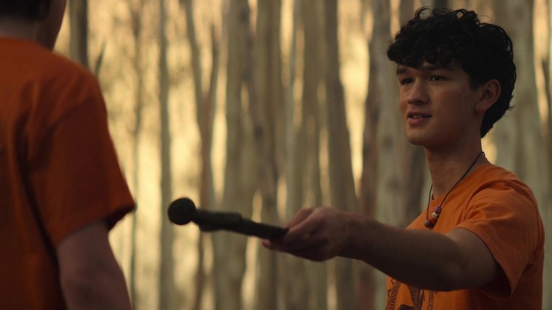 Charlie Bushnell's Luke hands a blade to Walker Scobell's Percy in Percy Jackson and the Olympians