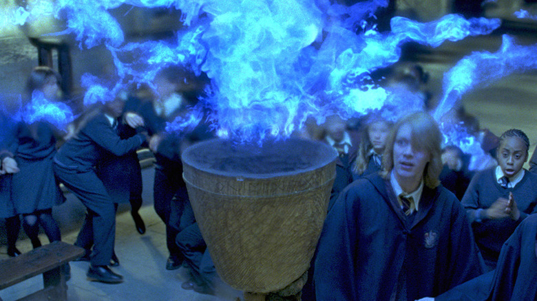 Students and Fred Weasley surrounding the Goblet of Fire in Harry Potter and the Goblet of Fire