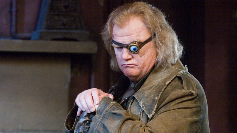 Mad-Eye Moody with his magical blue eye and cane looking down in Harry Potter and the Goblet of Fire