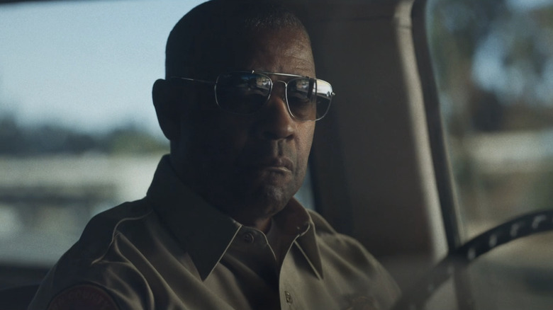 Denzel Washington's Joe Deacon sits in his car wearing shades in The Little Things