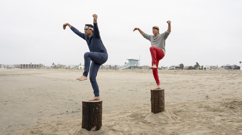 Daniel LaRusso and Johnny Lawrence training on the beach on Cobra Kai