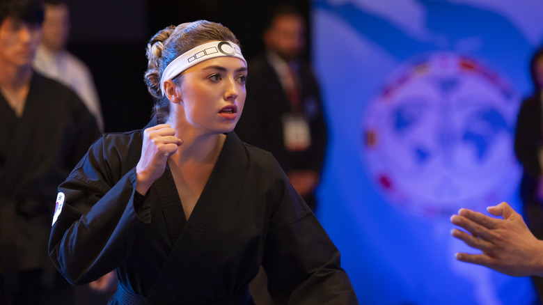 Tory Nichols doing karate in a headband at the Sekai Taikai on Cobra Kai