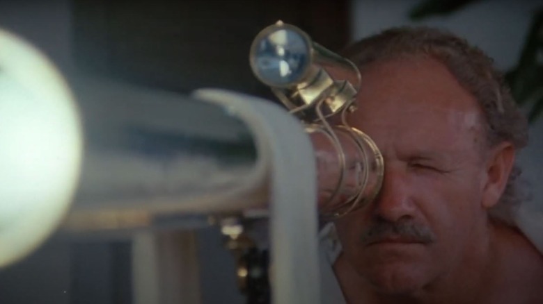 Gene Hackman's Jack McCann looking through a telescope in Eureka