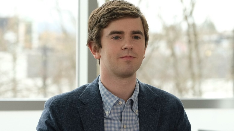 Dr. Sean Murphy sits in front of the window and smiles in the film 