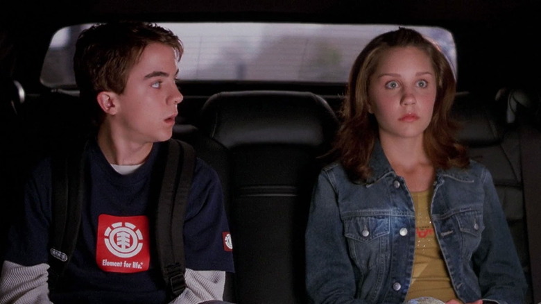 Jason and Kaylee looking surprised in the back of a limousine in Big Fat Liar