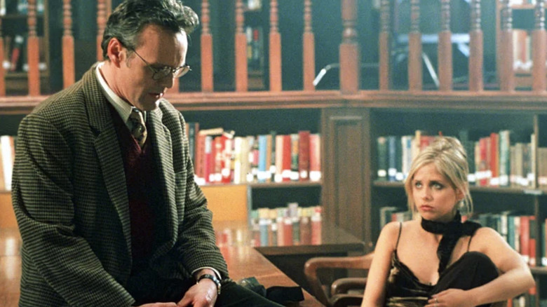 Giles talking to Buffy in the library