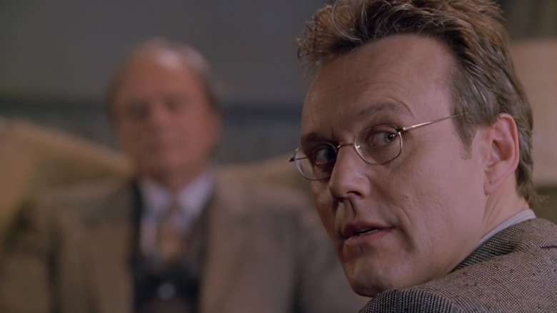 Giles looks directly to the camera with anxiety