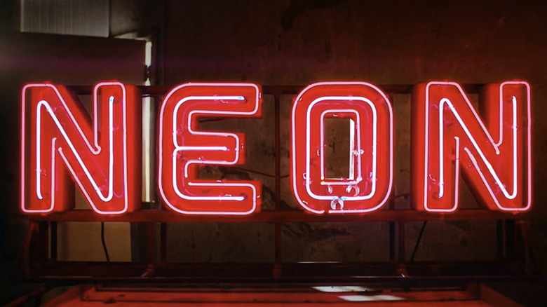 Red letters spelling the word Neon with white neon tubes inside each letter