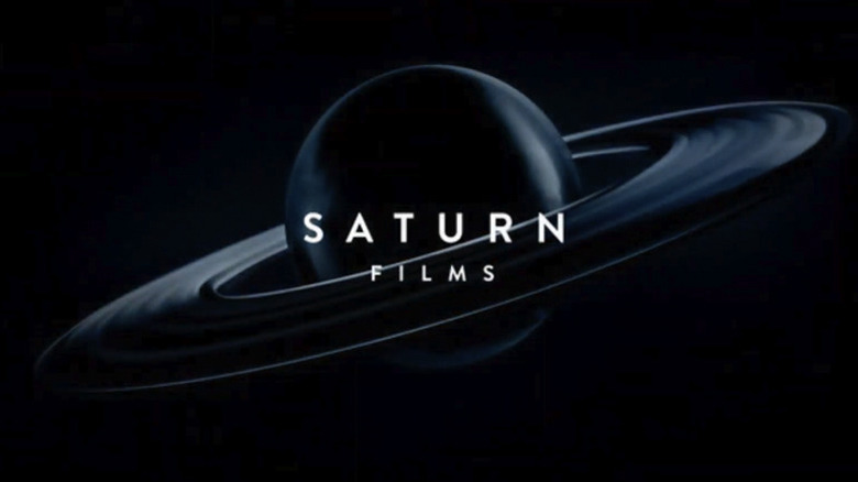 The planet Saturn with its rings tilted on an angle, set against a black background, with white text on top reading Saturn Films