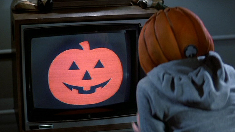 A child sitting in front of the TV during a Silver Shamrock commercial in Halloween III: Season of the Witch