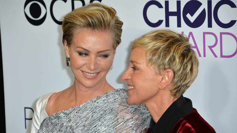 Portia de Rossi and Ellen DeGeneres smiling on a red carpet