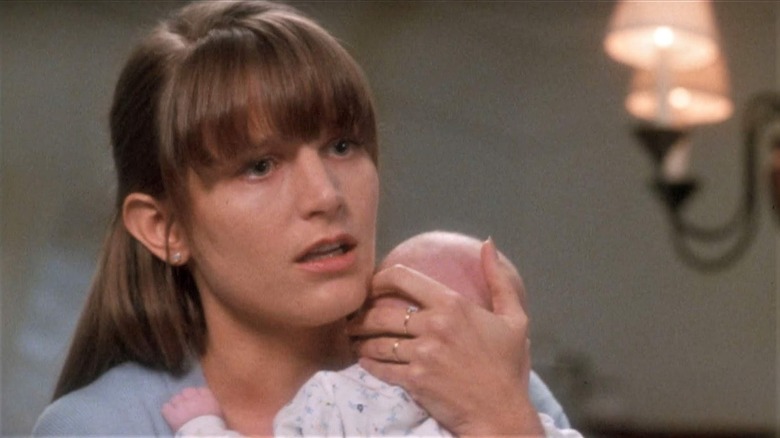 Bridget Fonda as Sarah, holding her baby, in A Simple Plan