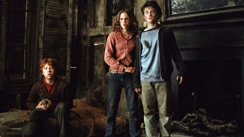 Ron holding Scabbers with Hermione and Harry in the Shrieking Shack in Harry Potter and the Prisoner of Azkaban