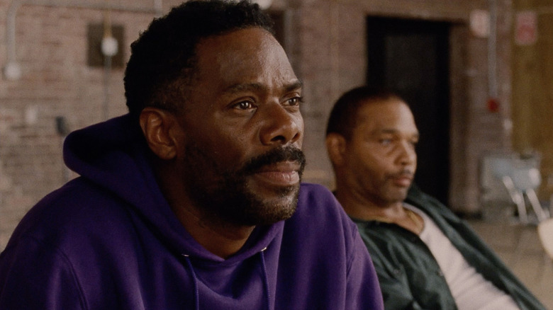 Colman Domingo as John "Divine G" Whitfield and Clarence Maclin as himself sitting next to each other at a correctional facility in Sing Sing