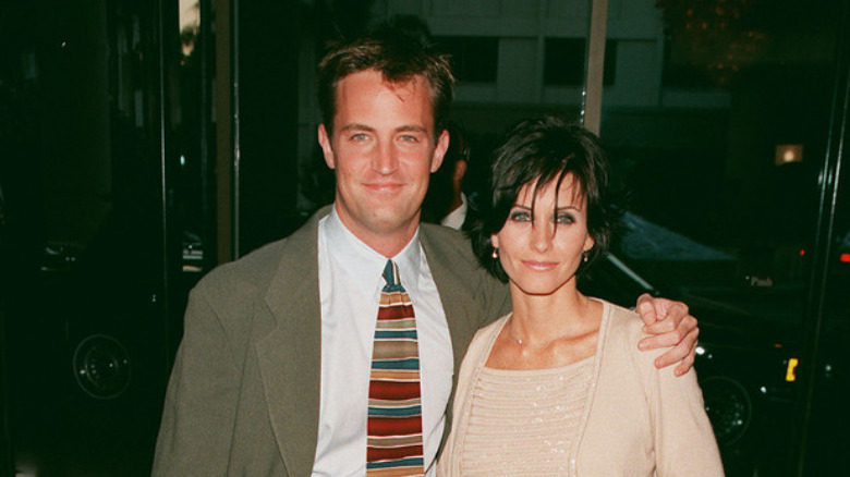 Matthew Perry and Courteney Cox smiling at a gala