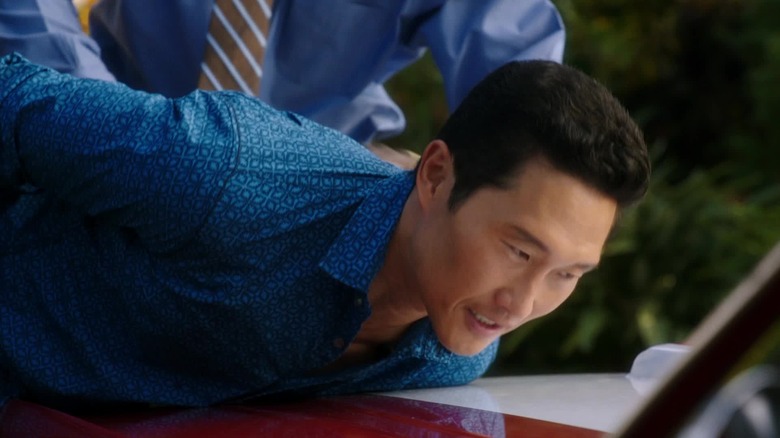 Daniel Dae Kim as Chin Ho Kelly being bent over the hood of a car and arrested in Hawaii Five-0