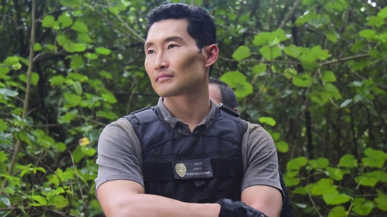 Daniel Dae Kim as Chin Ho Helly with his arms crossed in a bulletproof vest in Hawaii Five-0