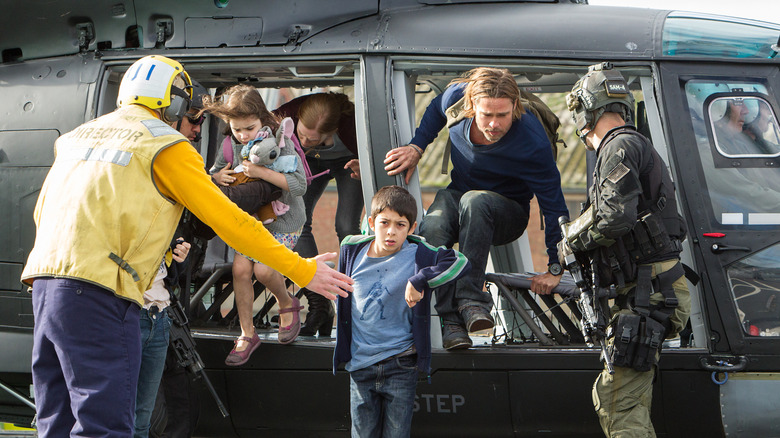 Brad Pitt exiting a helicopter