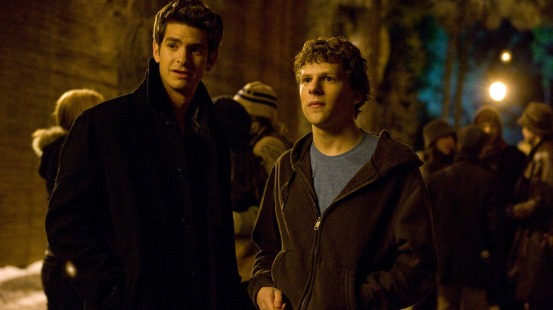 Andrew Garfield and Jesse Eisenberg standing outside in the cold