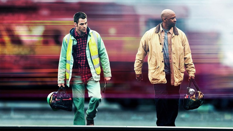 Chris Pine as Will Colson and Denzel Washington as Frank Barnes in front of a train in Unstoppable