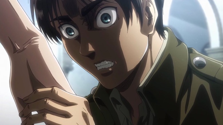 Eren grinning as he grabs Historia's hand in Attack on Titan