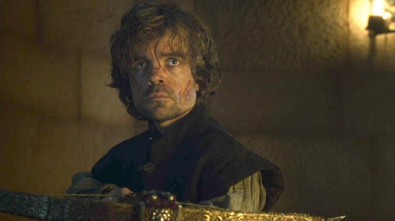 Tyrion holding a crossbow and looking sad on Game of Thrones