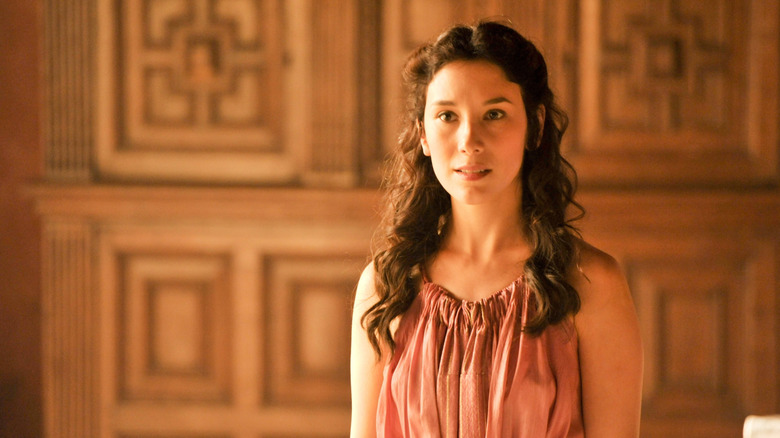 Shae in a pink dress half smiling on Game of Thrones