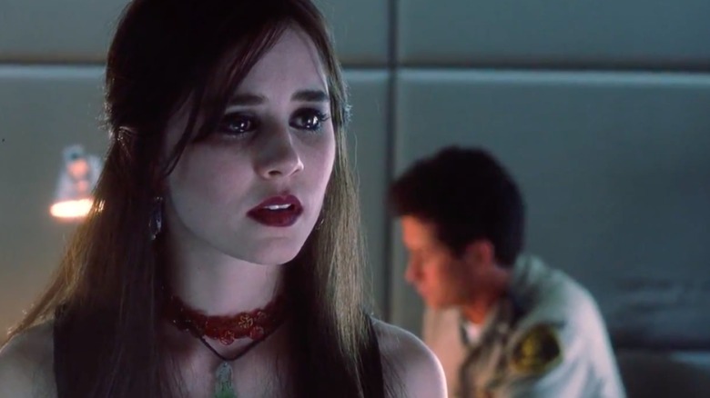 Alison Lohman, with dark hair and eyeliner, looks close to tears as Astrid in White Oleander