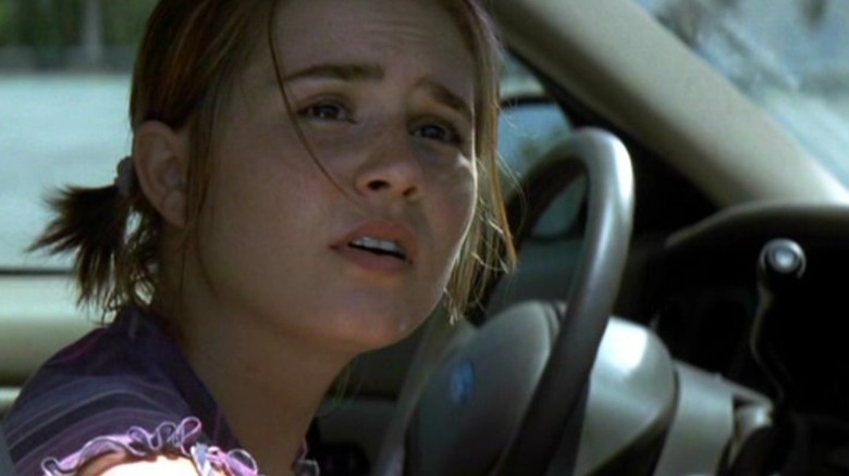 Alison Lohman's Angela looks plaintively out from the driver's seat of a car in Matchstick Men