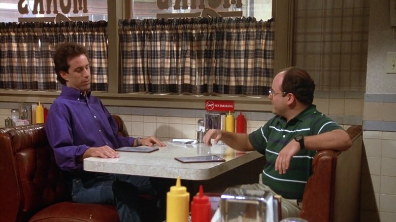 Jerry Seinfeld as Jerry and Jason Alexander as George sitting in a diner on Seinfeld