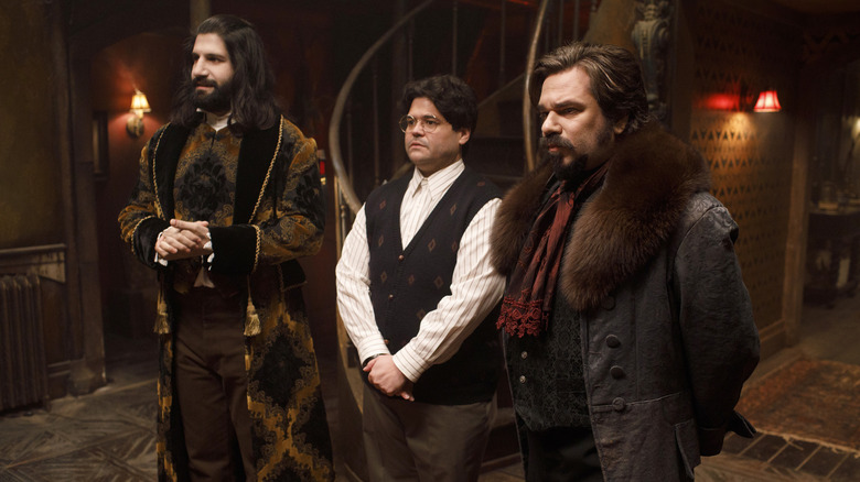 Nandor, Guillermo, and Lazlo lined up in the house in What We Do in the Shadows