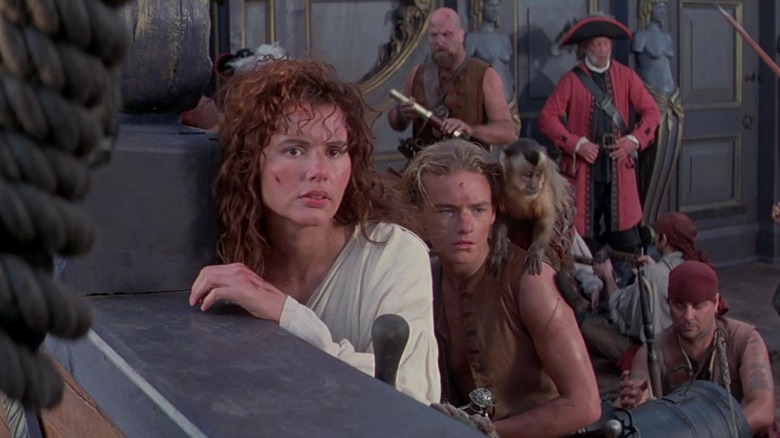 Geena Davis as Morgan Adams leaning against the side of a boat in Cutthroat Island