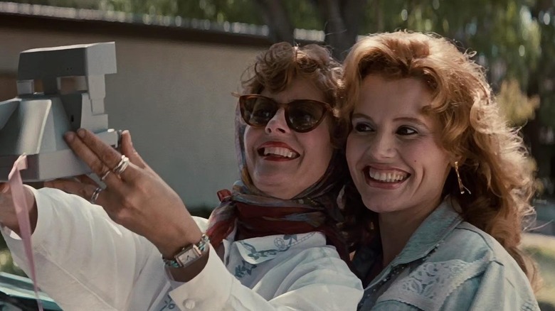 Susan Sarandon as Louise and Geena Davis as Thelma taking a photo in Thelma & Louise