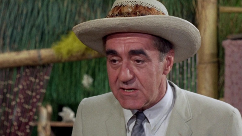 Mr. Howell in a hat in his hut on Gilligan's Island