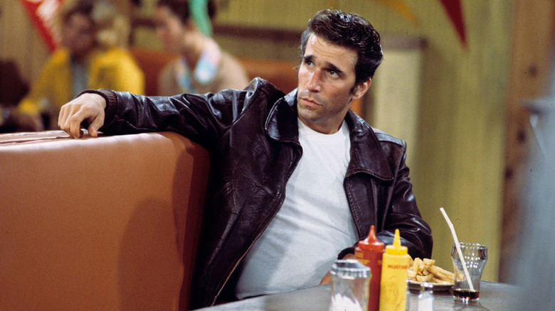 Fonzie sitting in a diner in Happy Days