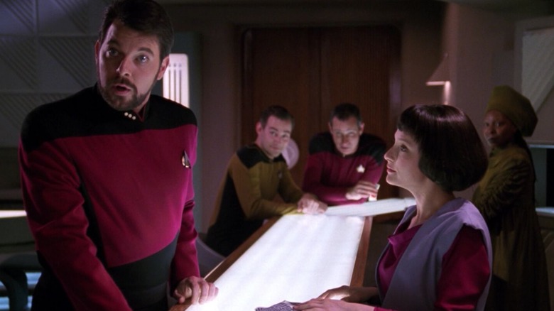 Riker, parecendo chocado em dez avanços, com a barra de tendência de Lal. Um episódio de Star Trek: The Next Generation.