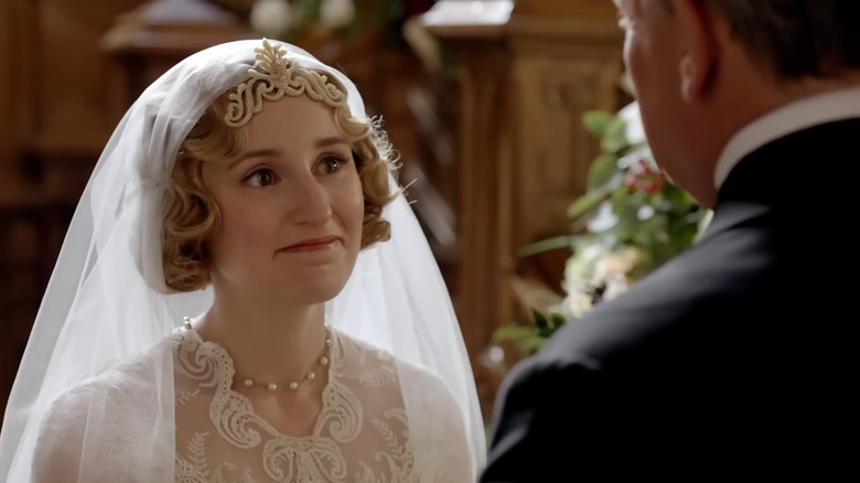 Lady Edith smiling in her wedding dress in Downton Abbey