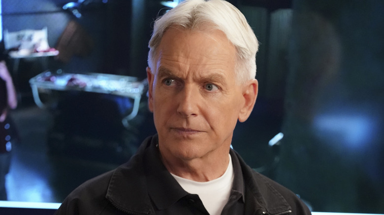 Leroy Jethro Gibbs standing in front of a blue backdrop on NCIS