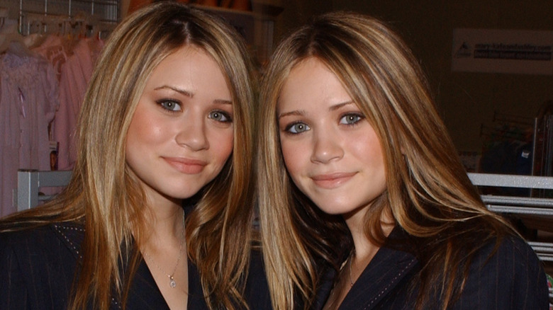 Mary-Kate and Ashley posing at an event