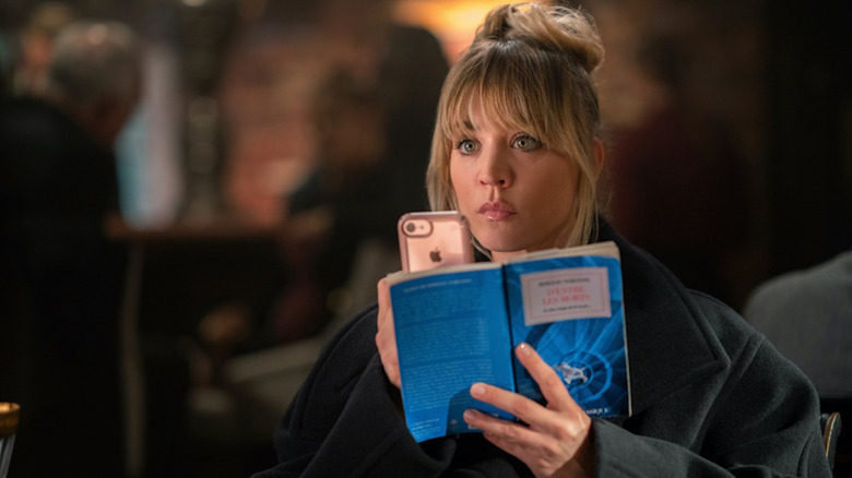 Kaley Cuoco as Cassie Bowden cracks open a book in The Flight Attendant