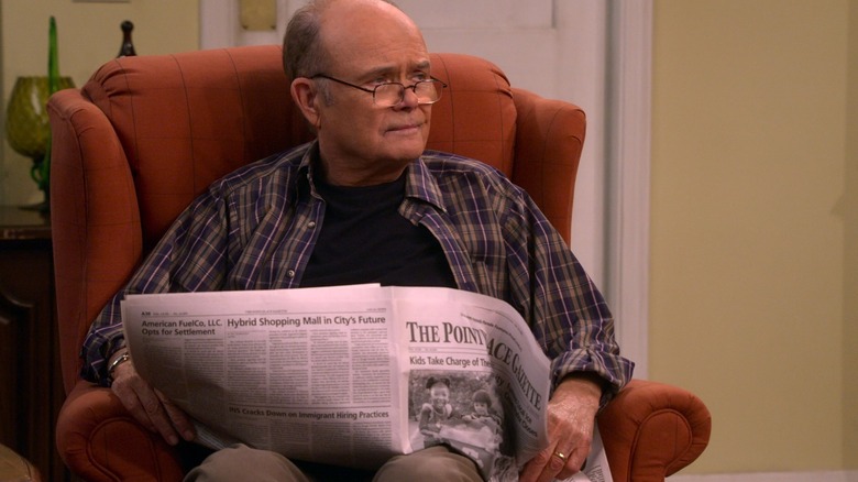 That 90s Show Kurtwood Smith as Red Forman sitting in chair reading newspaper