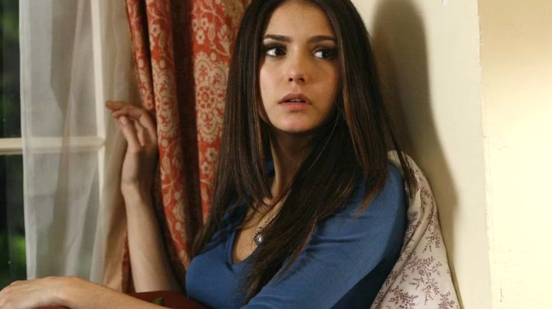 Elena sitting near her windowsill in Season 1 of The Vampire Diaries