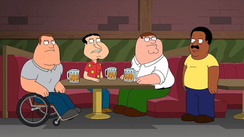 Joe, Peter, and Quagmire from 'Family Guy' sitting at a table, all collectively scowling at a standing Cleveland