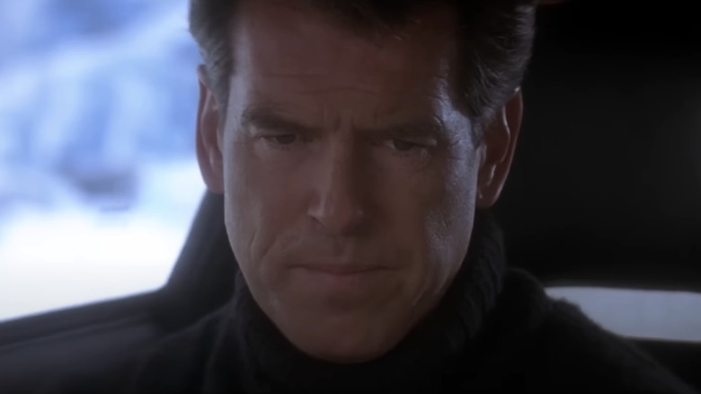 Pierce Brosnan's James Bond looks down while wearing a sweater in GoldenEye