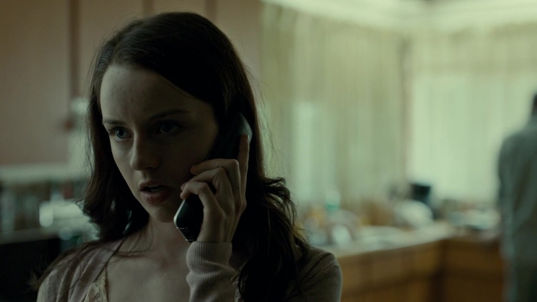 Kacey Rohl's Abigail answers a phone call in Hannibal